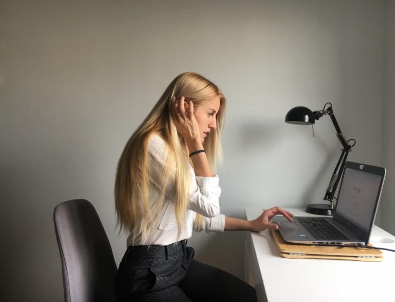 woman in office searching on her computer for a job rather than job crafting