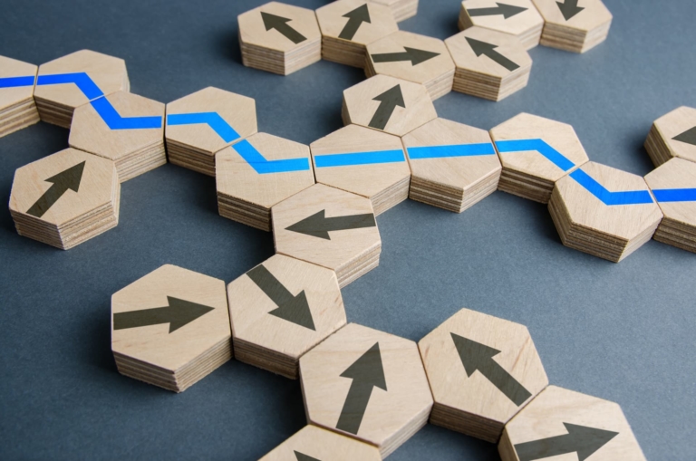 Wooden hexagons facing every direction with a blue optimal path guiding movement.
