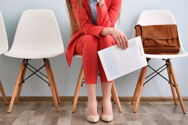 Young woman waiting for interview indoors.