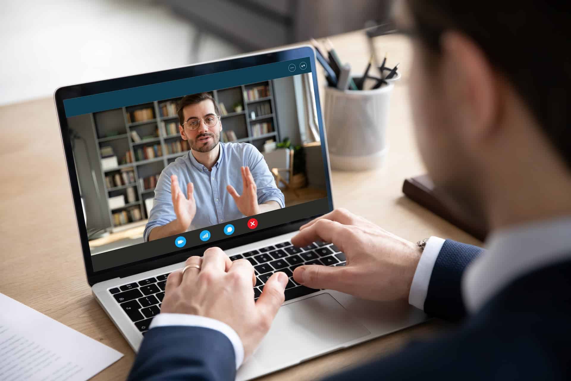 A man being interviewed over video call.