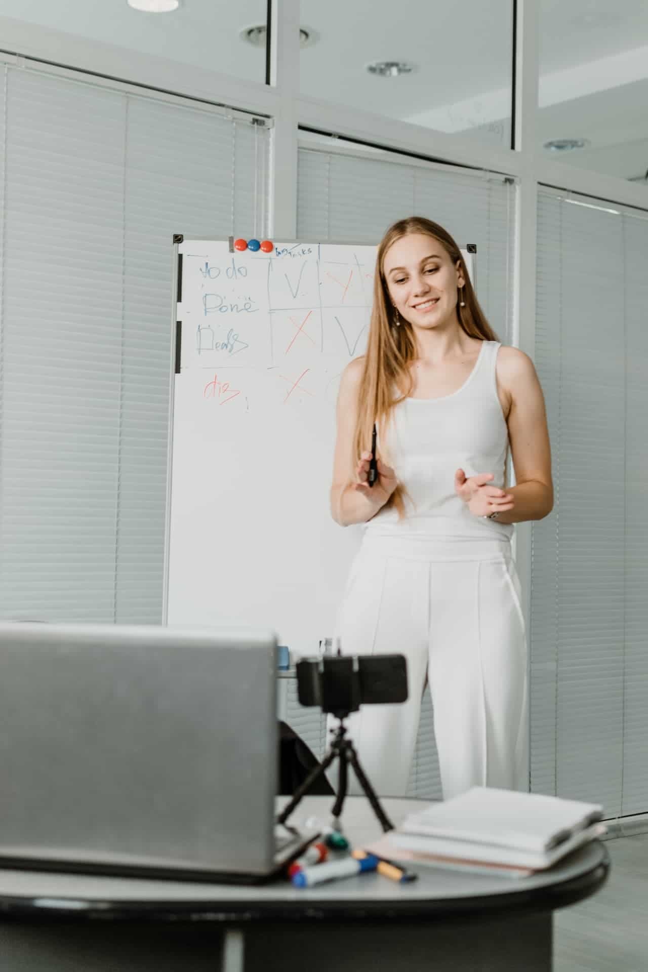 Young woman speaking in front of camera for vloggling.