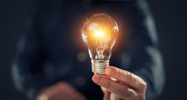 Closeup of a man's holding light bulb.