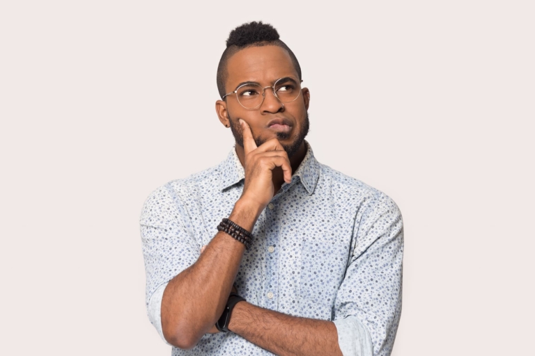 A man deep in thought, pondering a decision with a serious expression.
