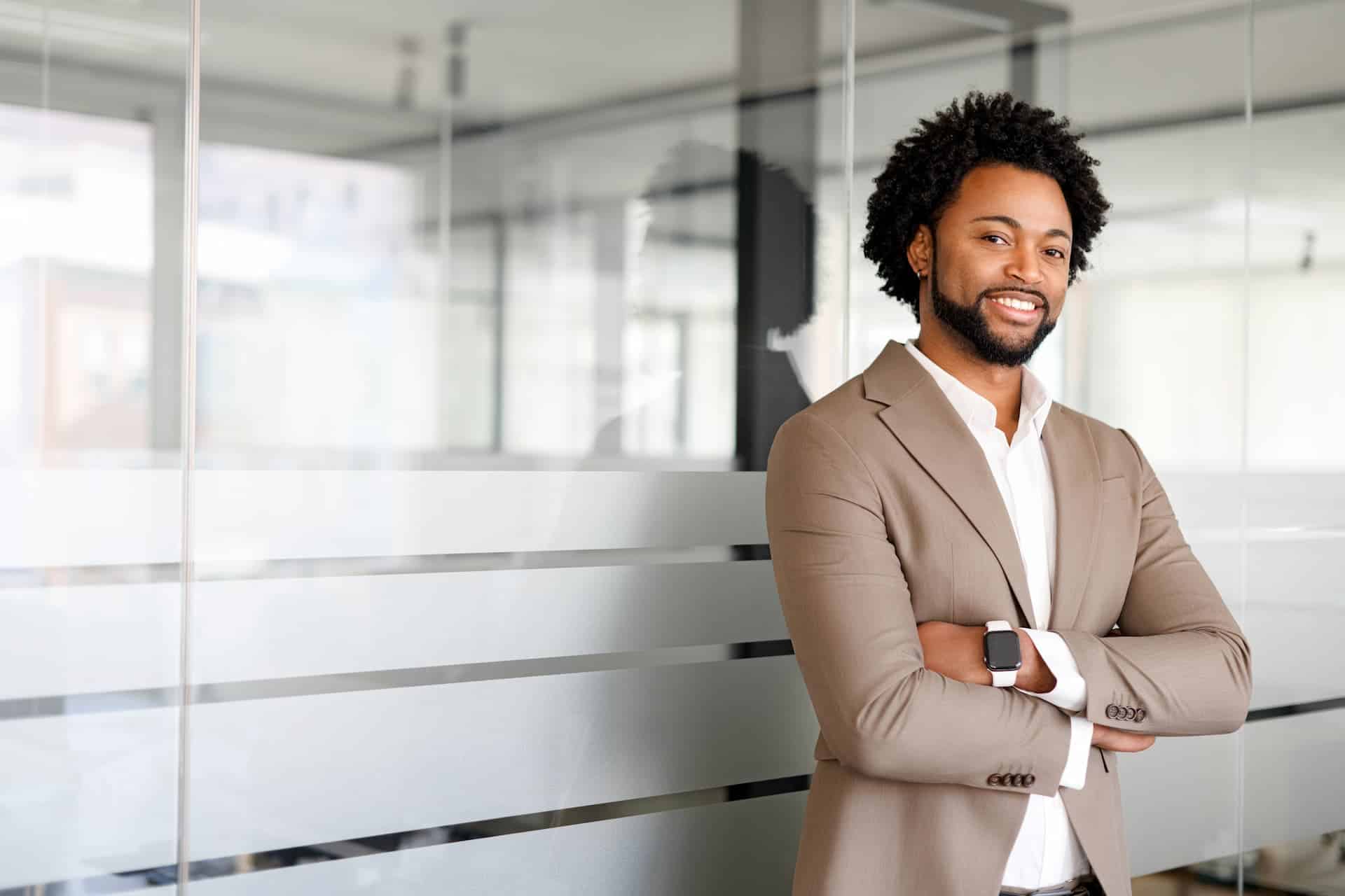 Depicting executive presence, a man exudes confidence in a beige suit, conveying professionalism and authority.
