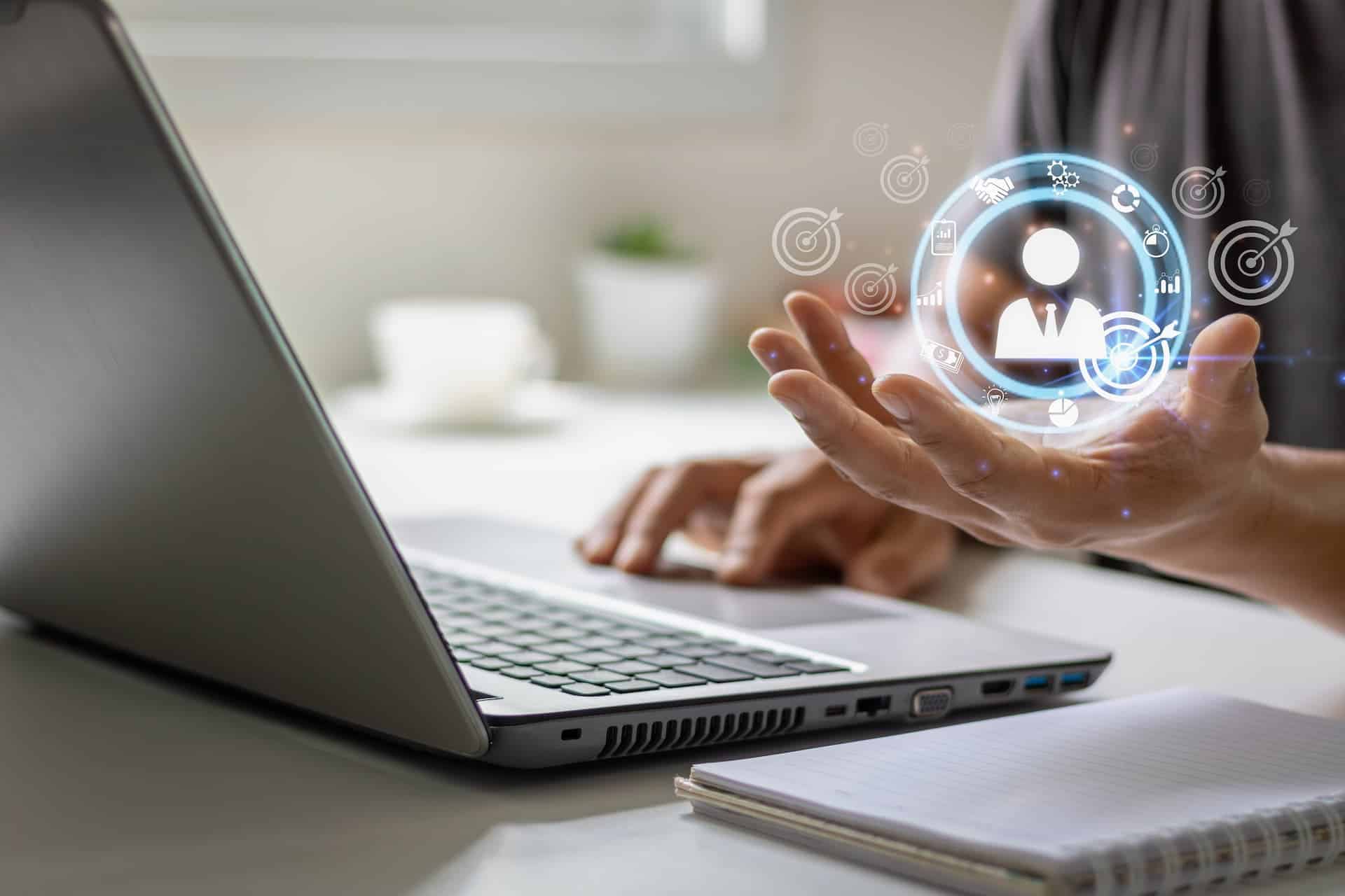 Close-up of a man's hands on a laptop keyboard, customizing his job search documents to align with a specific job opportunity while maintaining his personal brand.