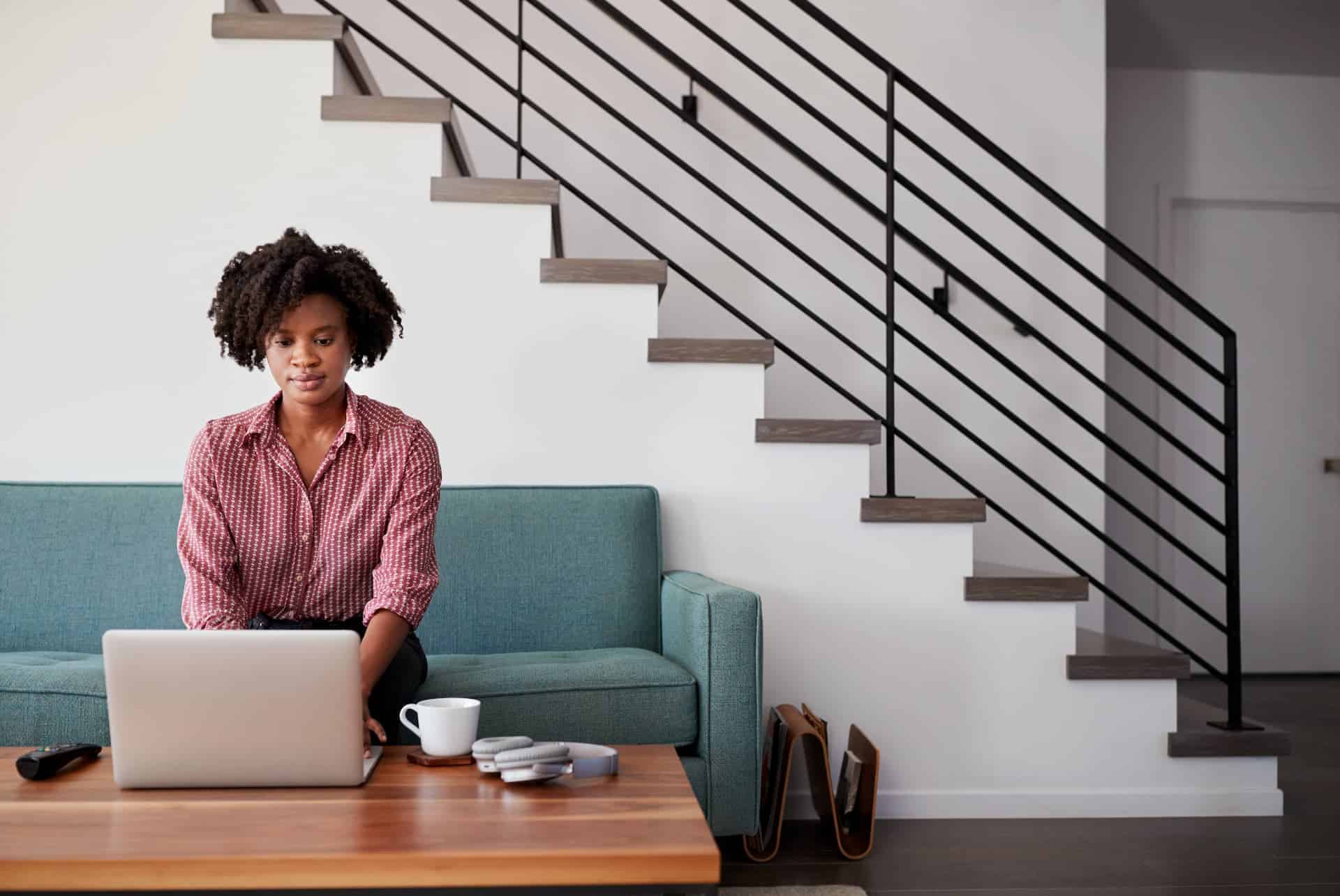 A woman working from home, illustrating the concept of side gigs and entrepreneurship beyond traditional office settings.