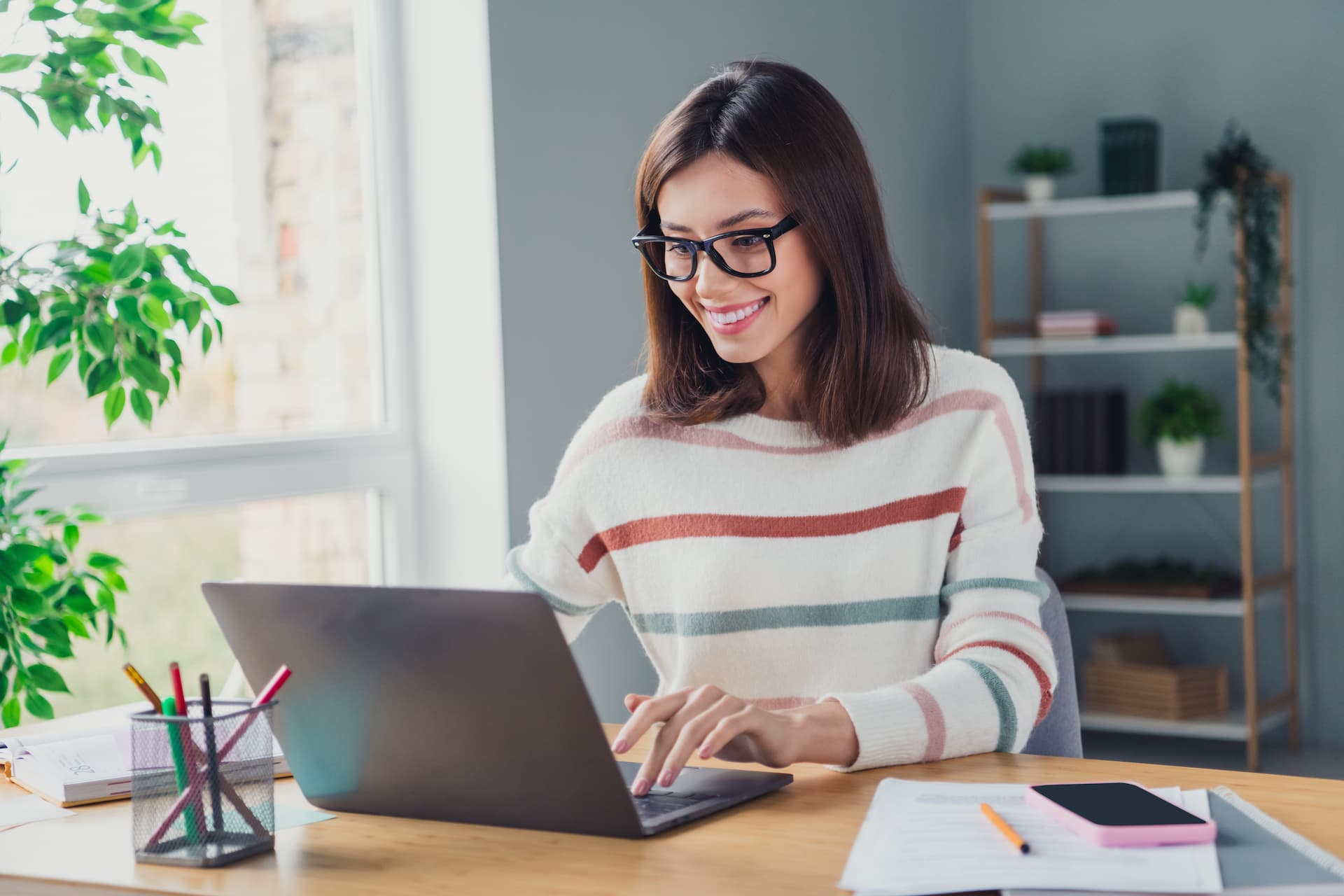 Woman typing on her laptop, actively searching for career-related resources to enhance her professional growth.