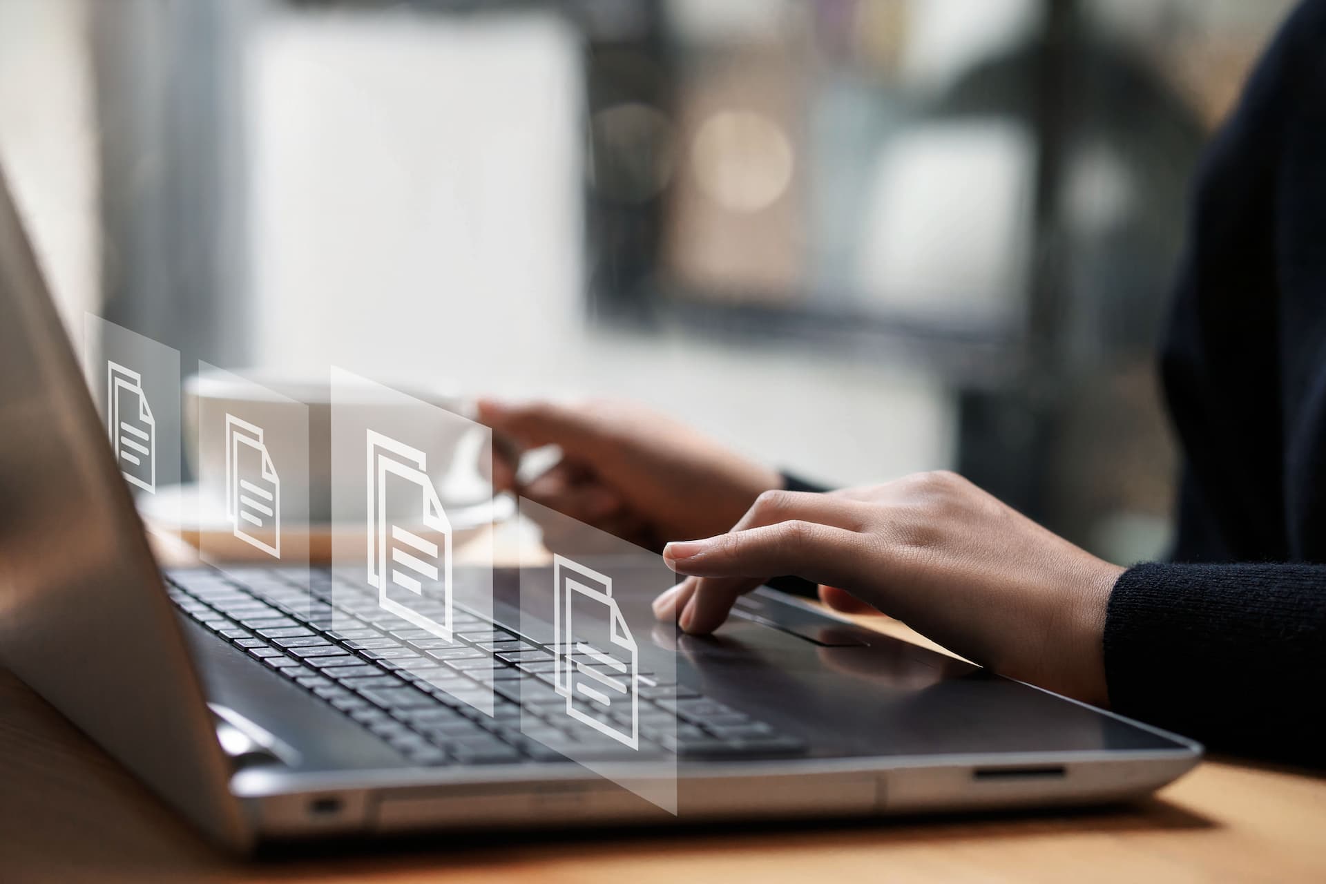 Woman's hands typing on a laptop with various icons emerging from the screen, symbolizing the wealth of career resources available for college students.