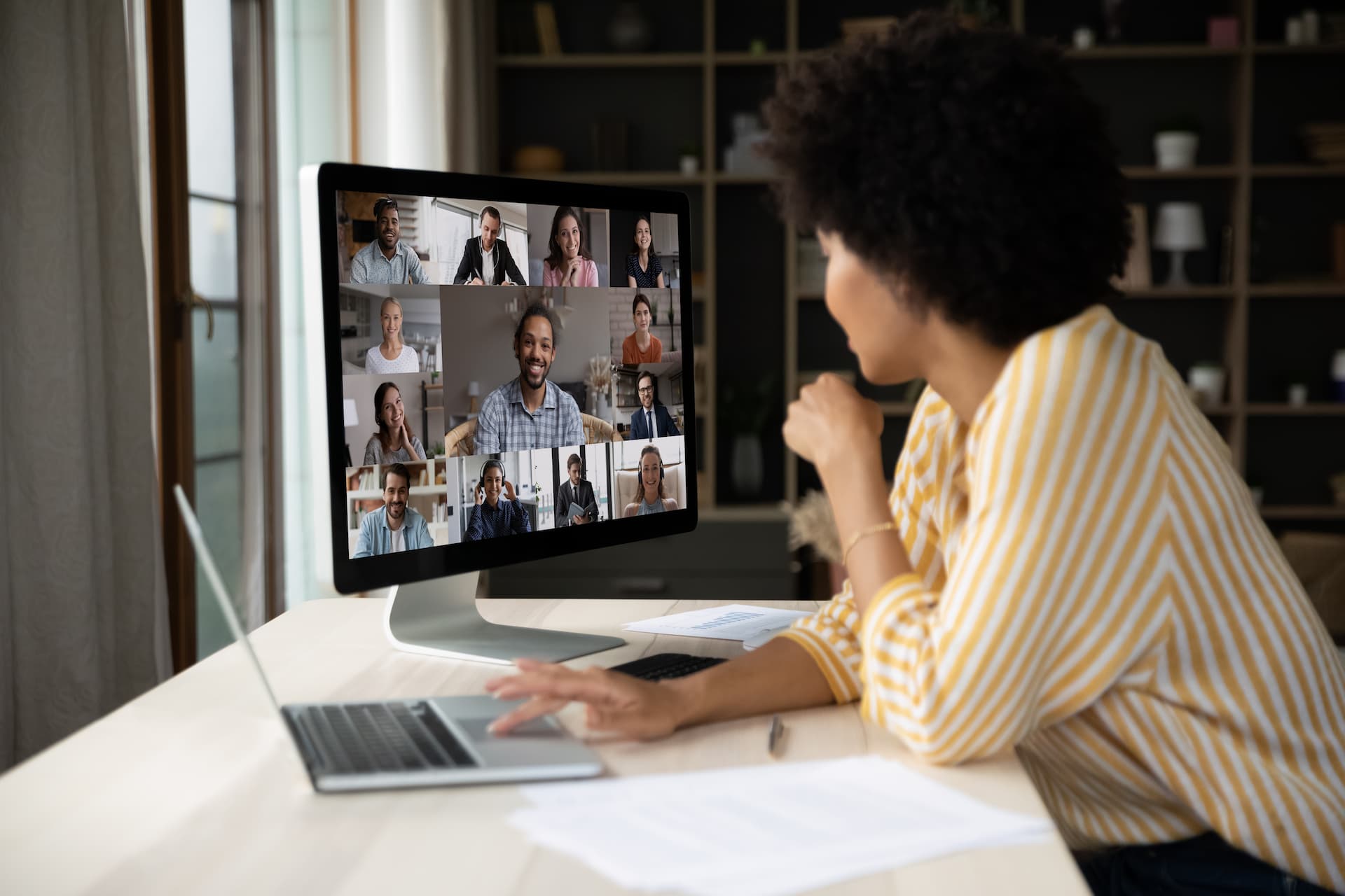 Woman in her home on an online call with numerous participants, representing the idea of a career-related support community that companies and HR professionals can rely on to help employees enhance their job skills.