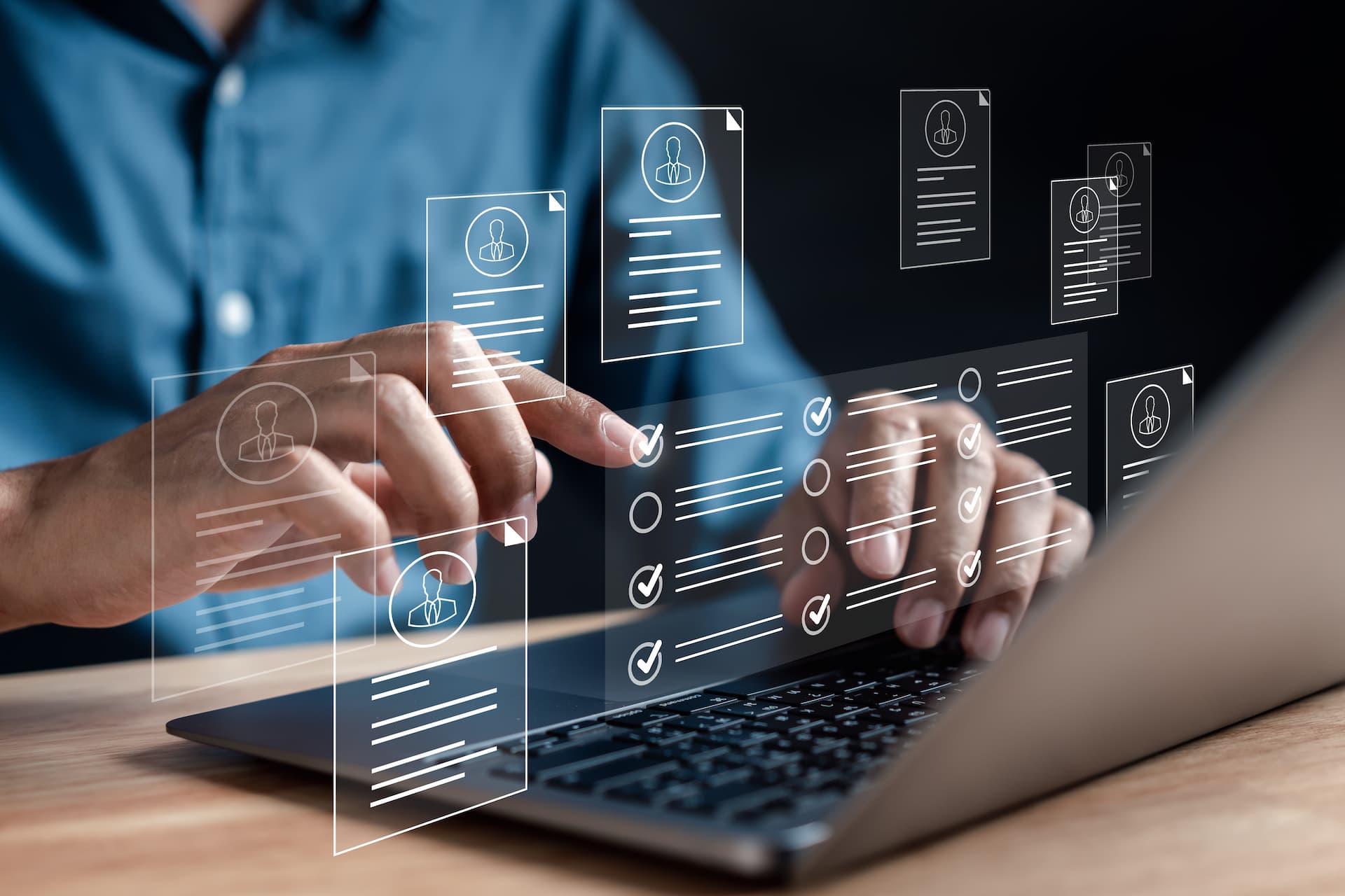 Man's hands typing on a laptop with various icons emerging from the screen, representing the abundance of coaching resources available.