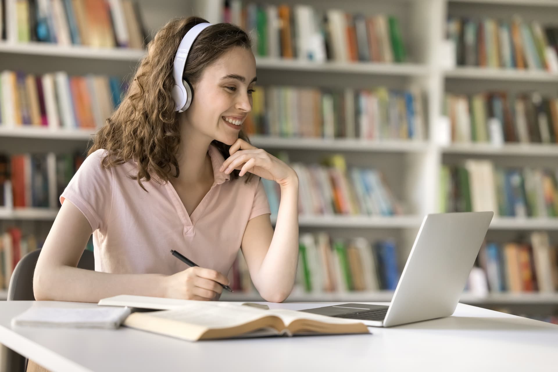 Student in a college library taking an online course about career development.