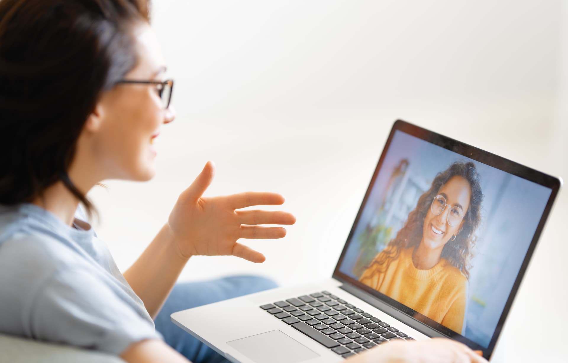 Woman speaking with her career coach via her laptop, receiving personalized guidance and support in career development.