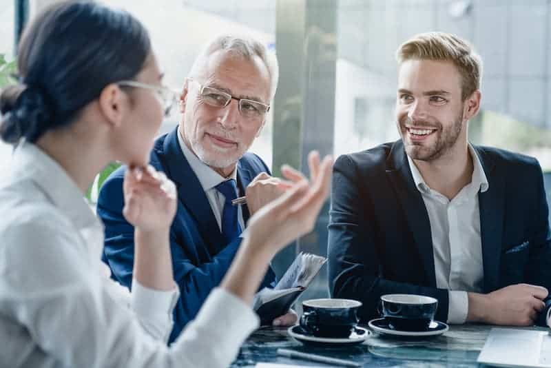 A group of colleagues engaged in a candid discussion in an office setting, emphasizing open communication and transparency in teamwork.