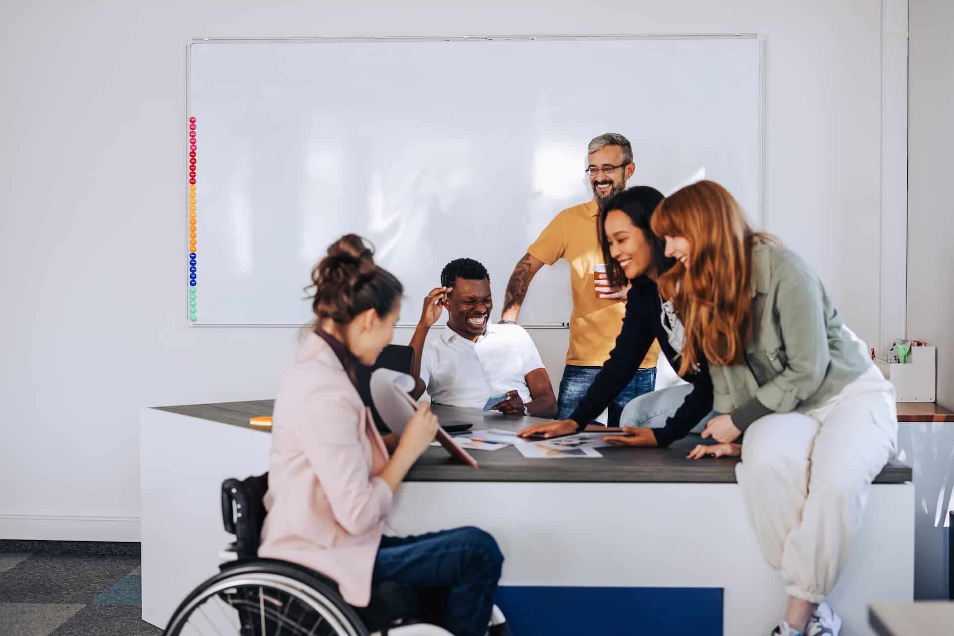Group of diverse professionals collaborating and laughing together.