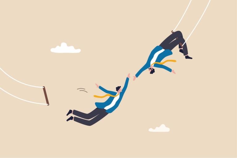 Illustration of two men in suits on trapeze swings, with one hanging upside down by his knees from the trapeze while the other leaps from his trapeze to grab the first man’s hand, symbolizing risk-taking in career management.
