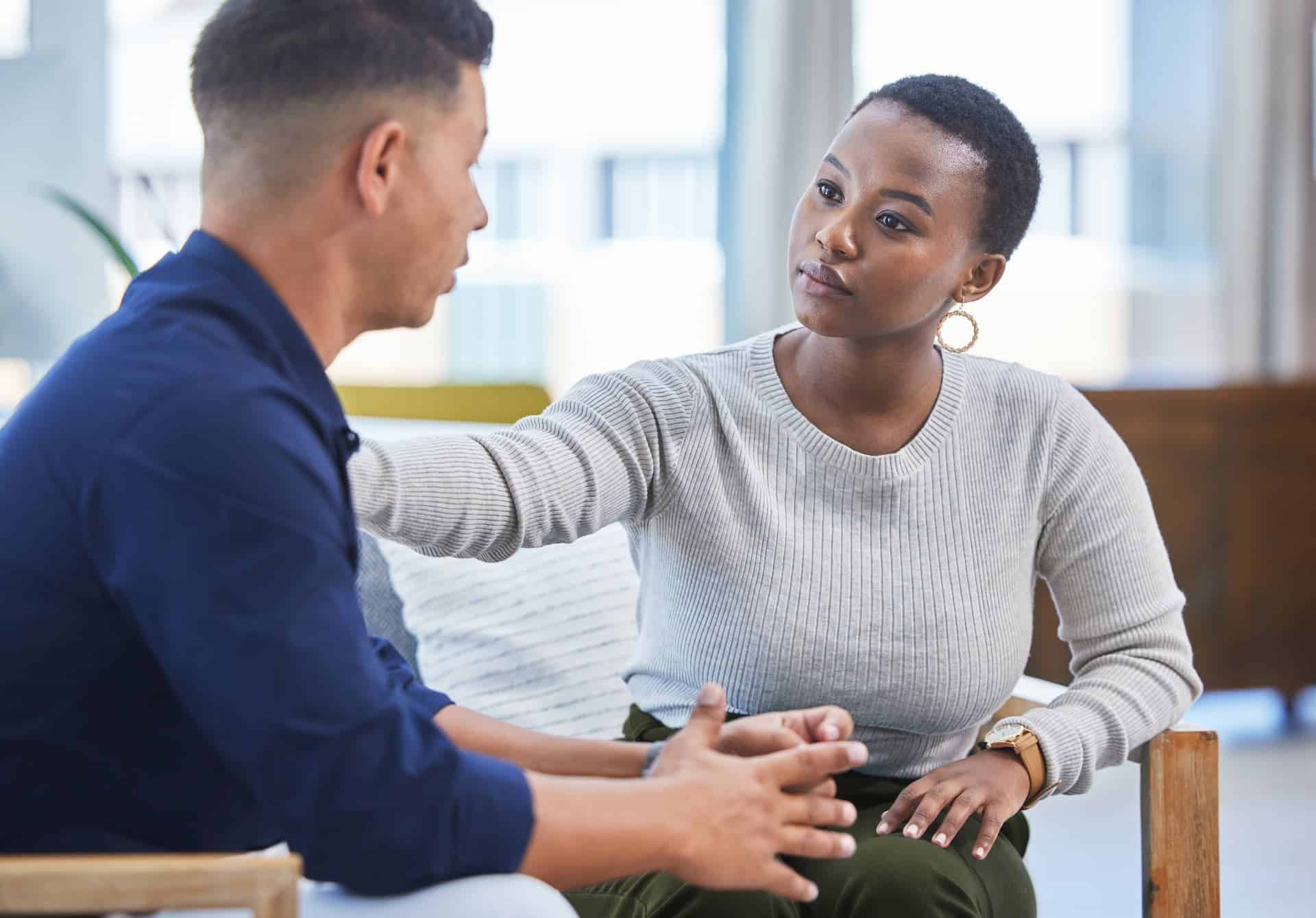 A woman providing social support to a man, emphasizing the role of connection in stress management.