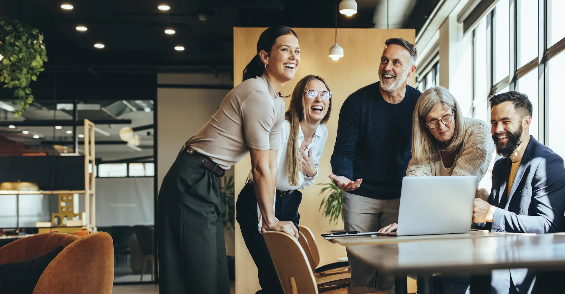A group of professionals engaged in discussion in an office setting, collaborating to brainstorm and solve problems together as they improvise solutions.