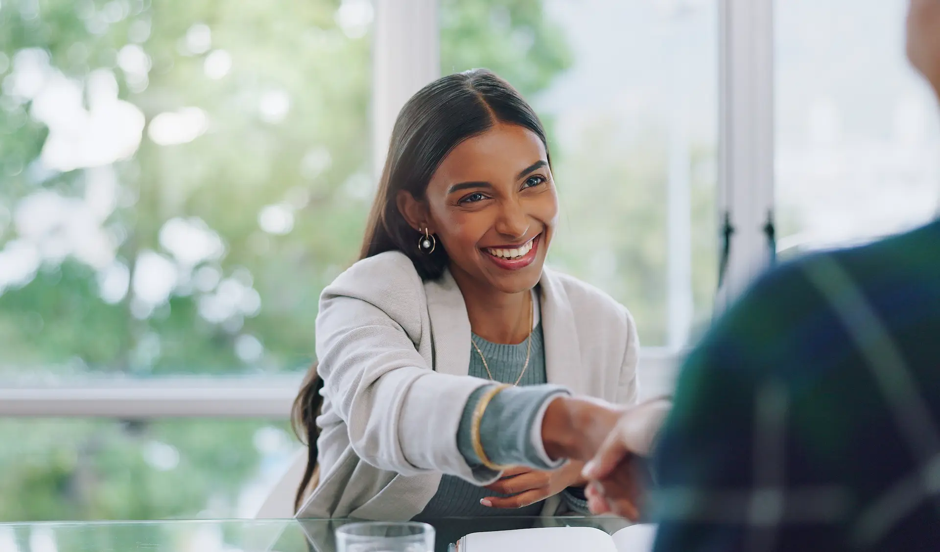 A woman shaking hands with her new mentor.