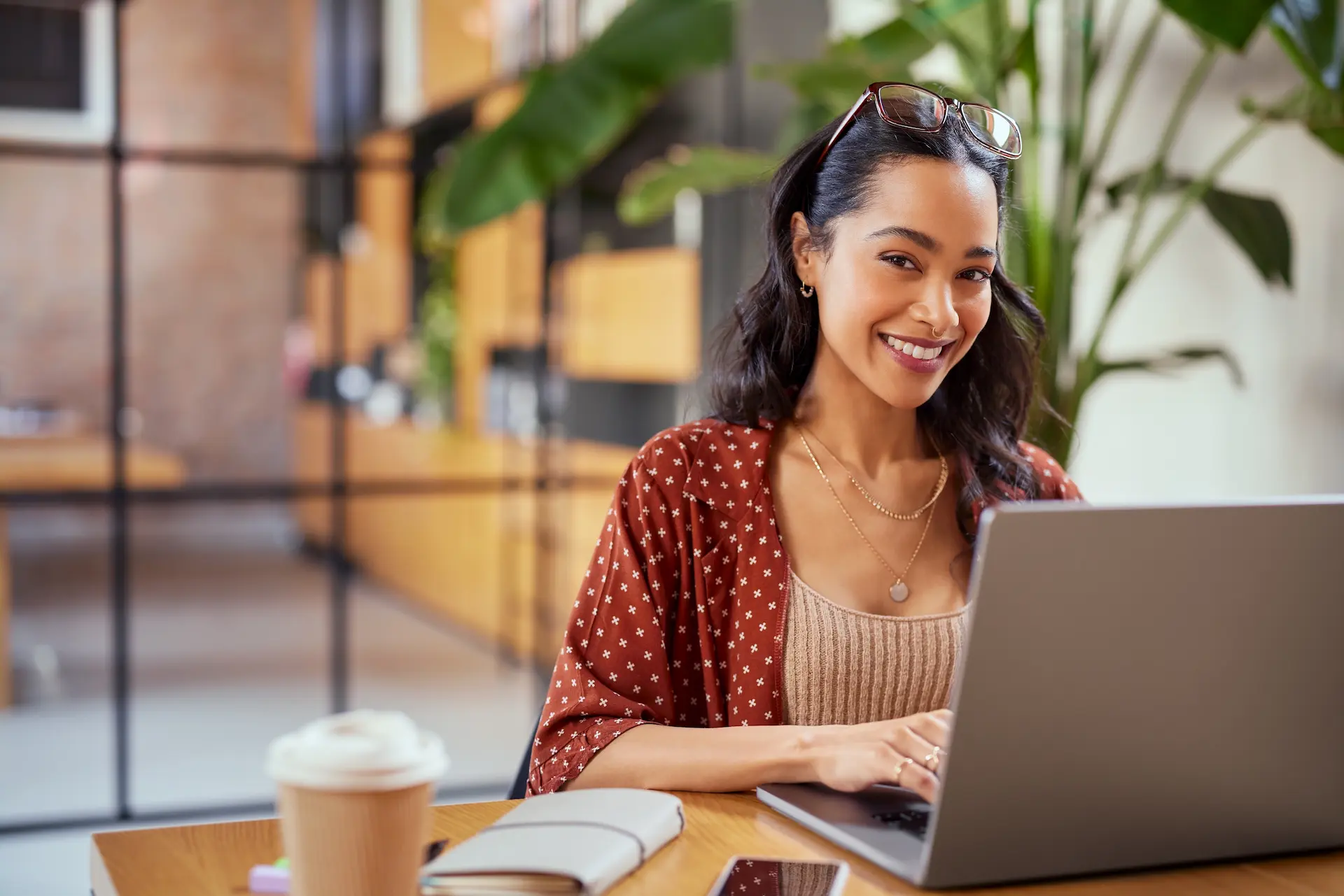 A woman types on her laptop at her desk, illustrating the continuous learning and adaptability required in an evolving work environment.