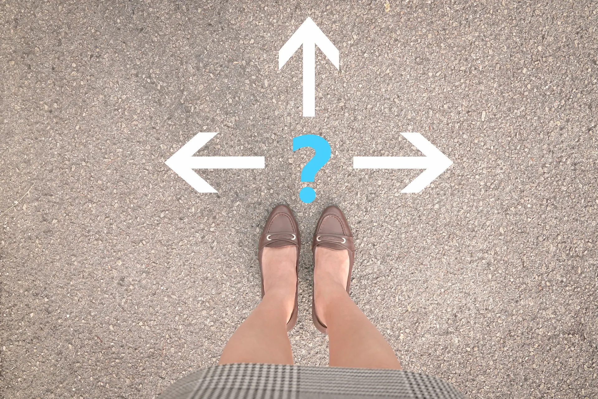 The feet of a woman standing in front of three arrows pointing in different directions, symbolizing her options to choosing her career path.