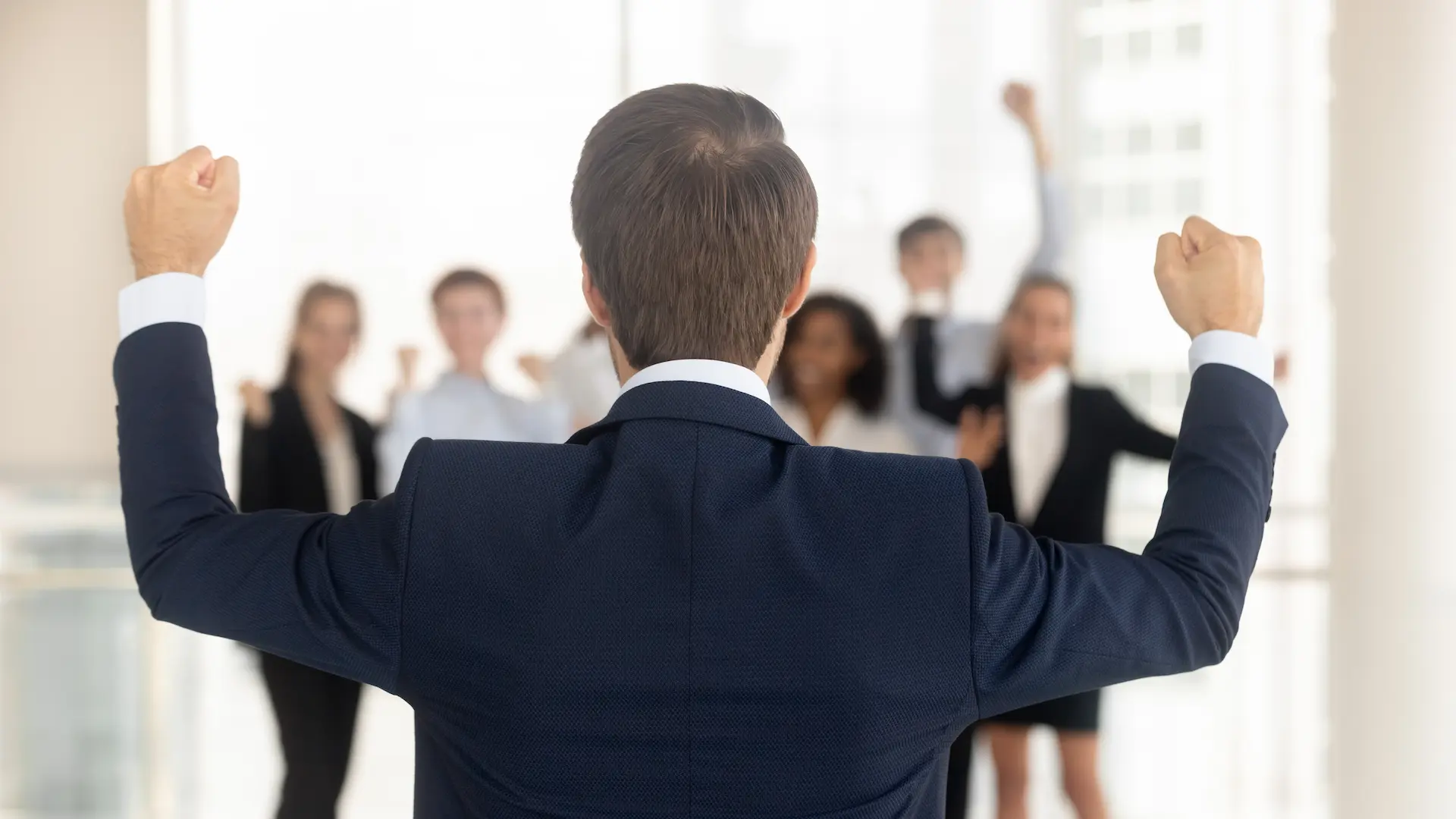 Team followership shown through mutual celebration, with a leader raising his fists and the team enthusiastically responding in support.