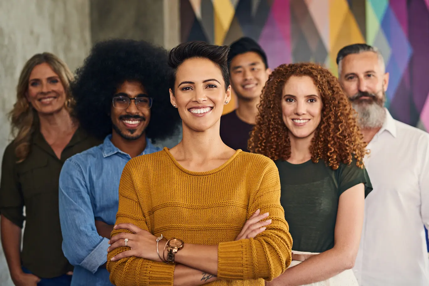 Strong followership dynamics illustrated through a confident woman standing in front of her supportive team.