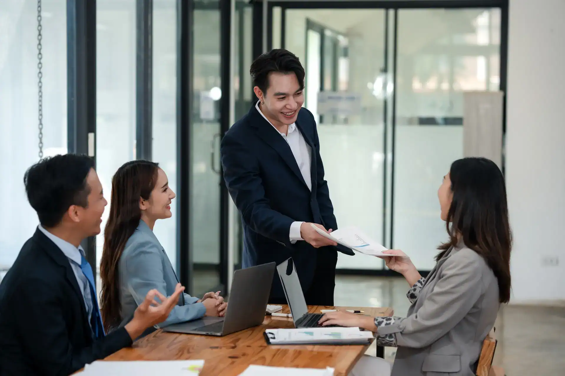 A leader delegates a specific task to a team member as part of a collaborative planning session.