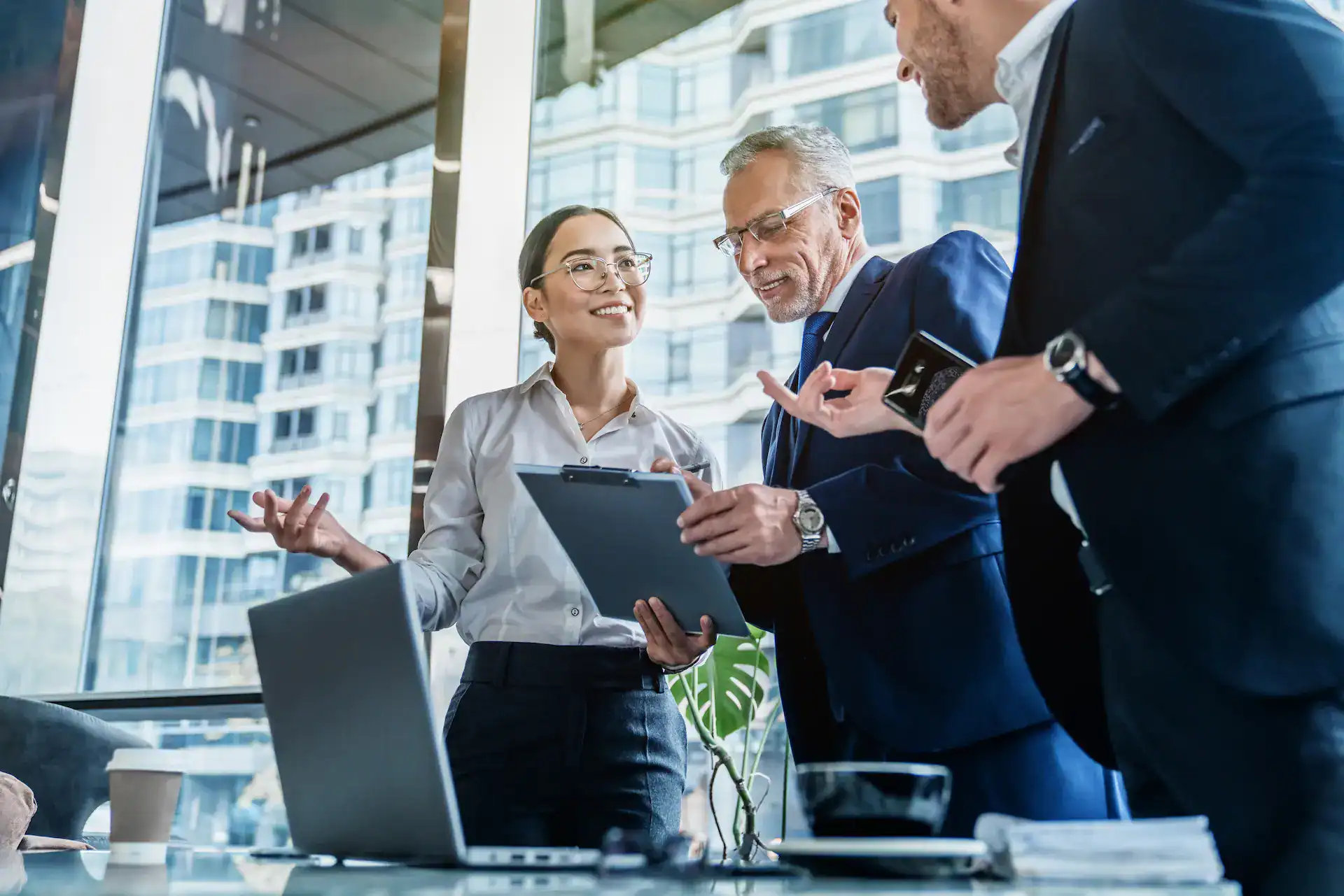 A woman having a persuasive conversation with two superiors, showcasing how organizational navigation often relies on connections and networking.