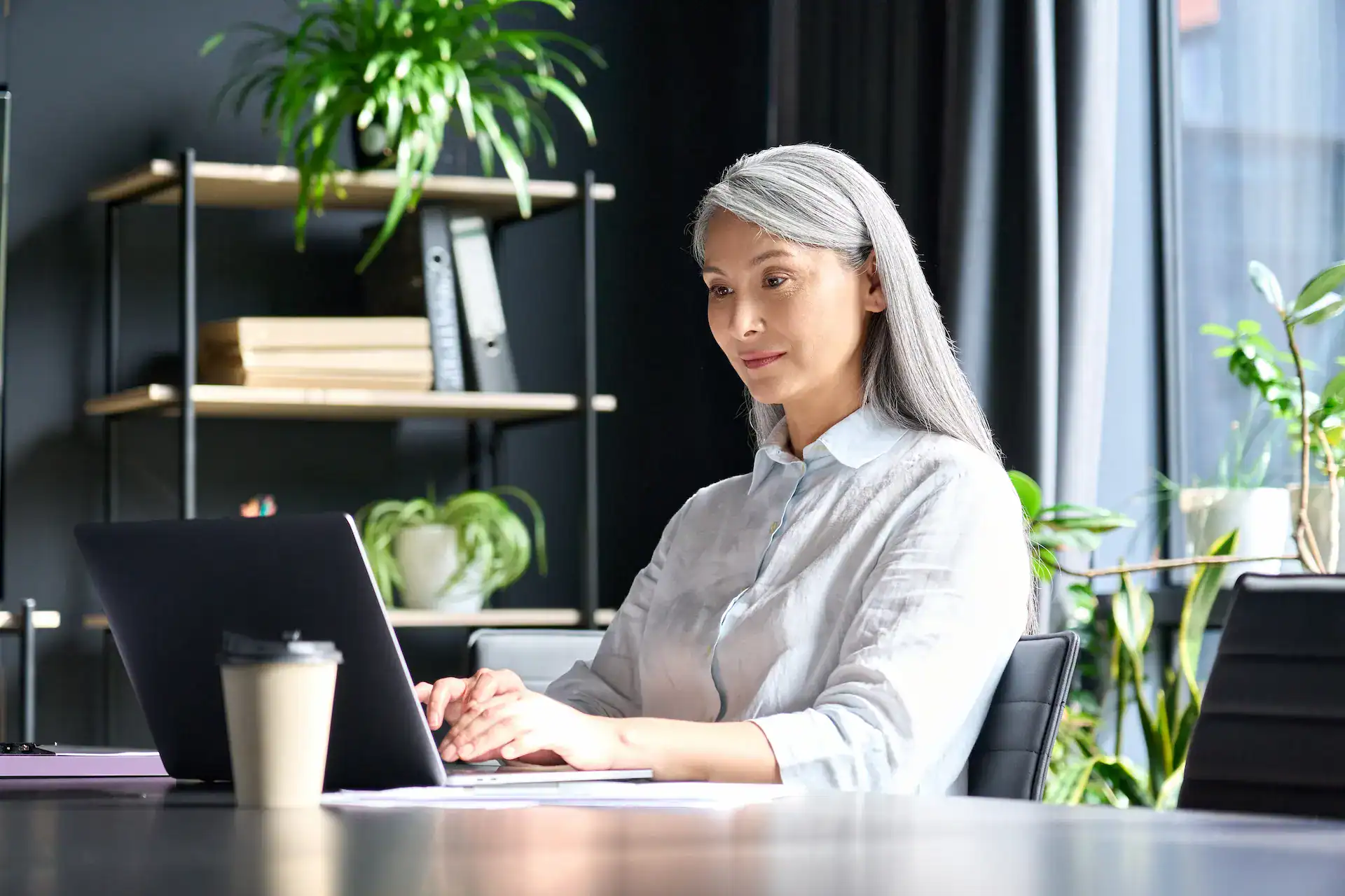 A woman updating her LinkedIn profile to reflect her thought leadership.