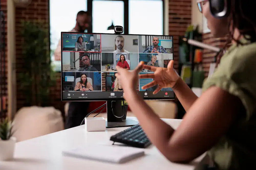 Online group coaching session with professionals meeting on a video call.