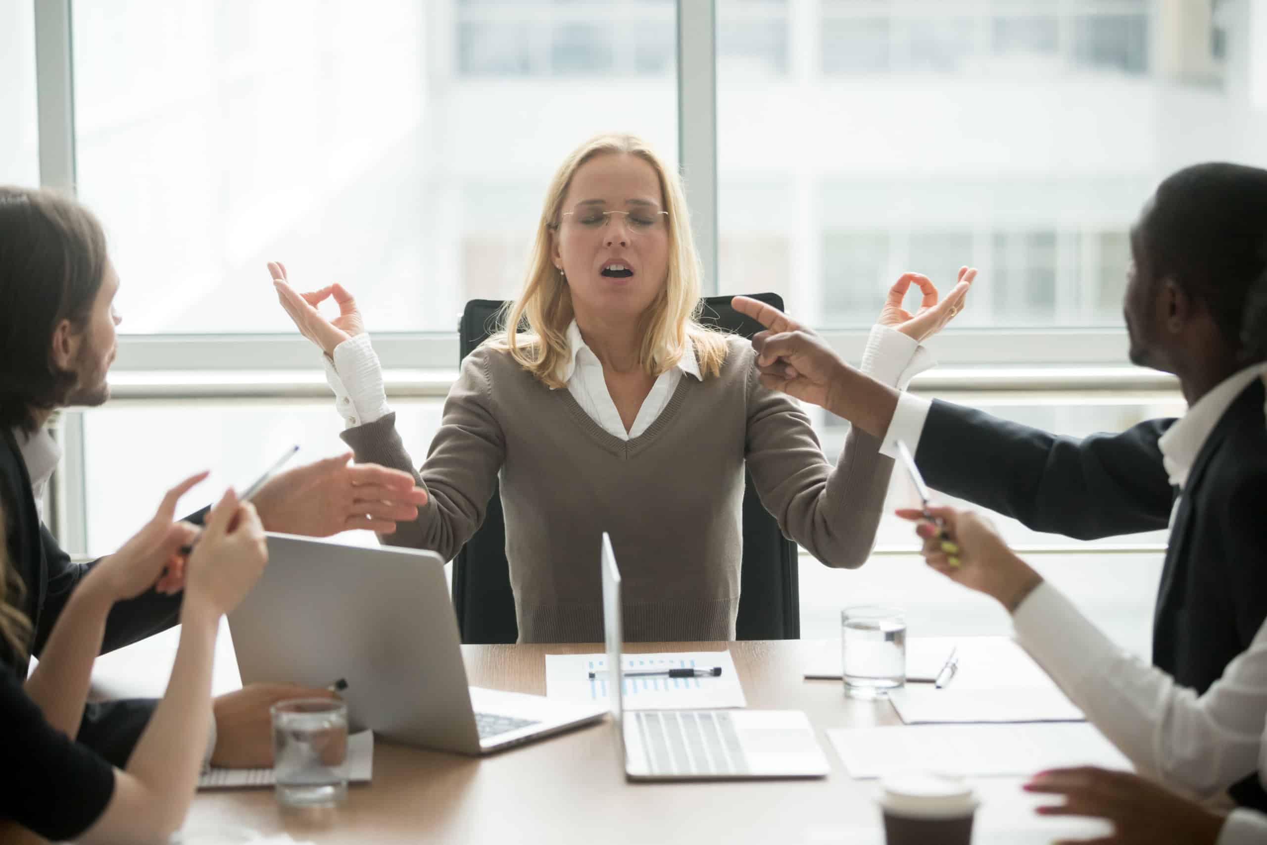 A woman trying to de-stress while participating in a high-stakes meeting .