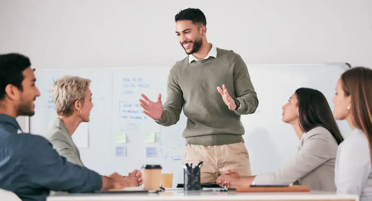 Business professional leading a workplace professional skills training session for a team.