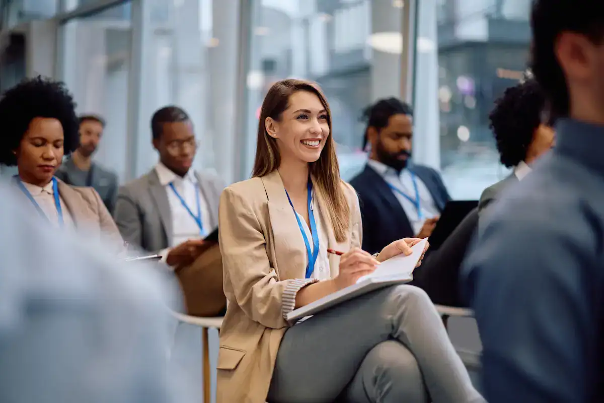 Business speaker engaging an audience during a professional conference presentation.