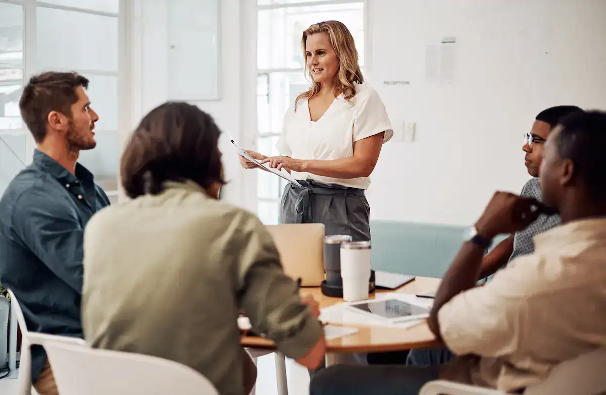 Facilitator leading a corporate training workshop with employees in a collaborative setting.