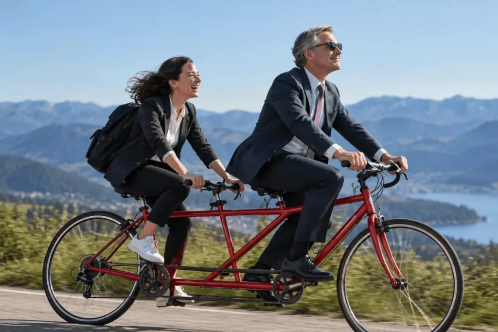 Boss and employee riding a tandem bicycle together, symbolizing teamwork, communication, and shared responsibility for building a successful working relationship.