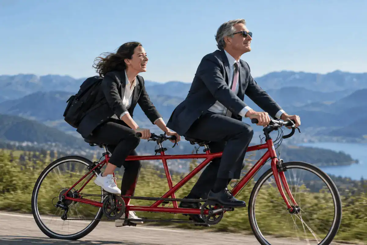 Boss and employee riding a tandem bicycle together, symbolizing teamwork, communication, and shared responsibility for building a successful working relationship.